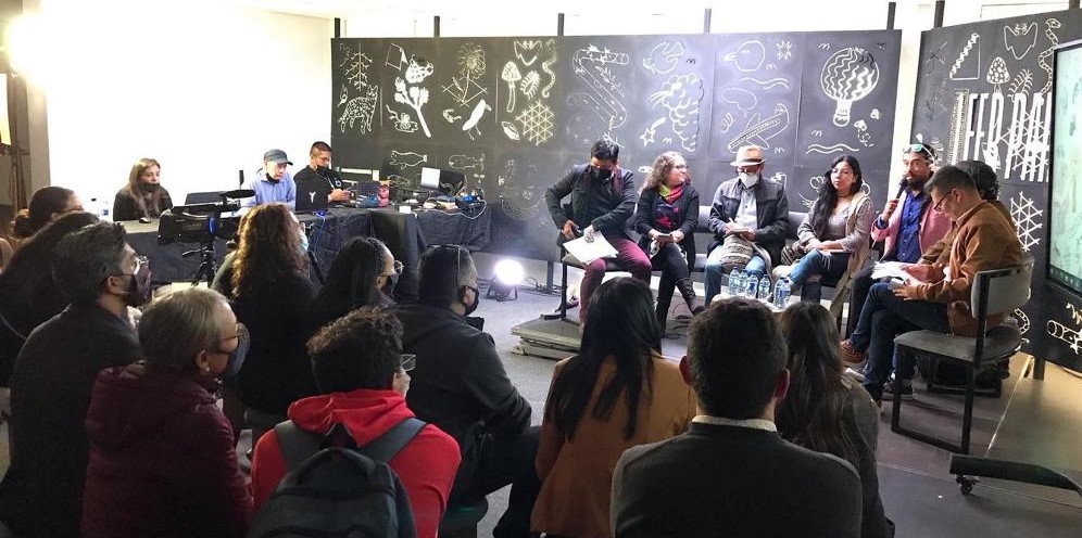 Fotografía de varios profes como expositores ante varios participantes en un salón de conferencias 